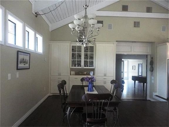  Dining area with built in cabinets adjacent from kitchen