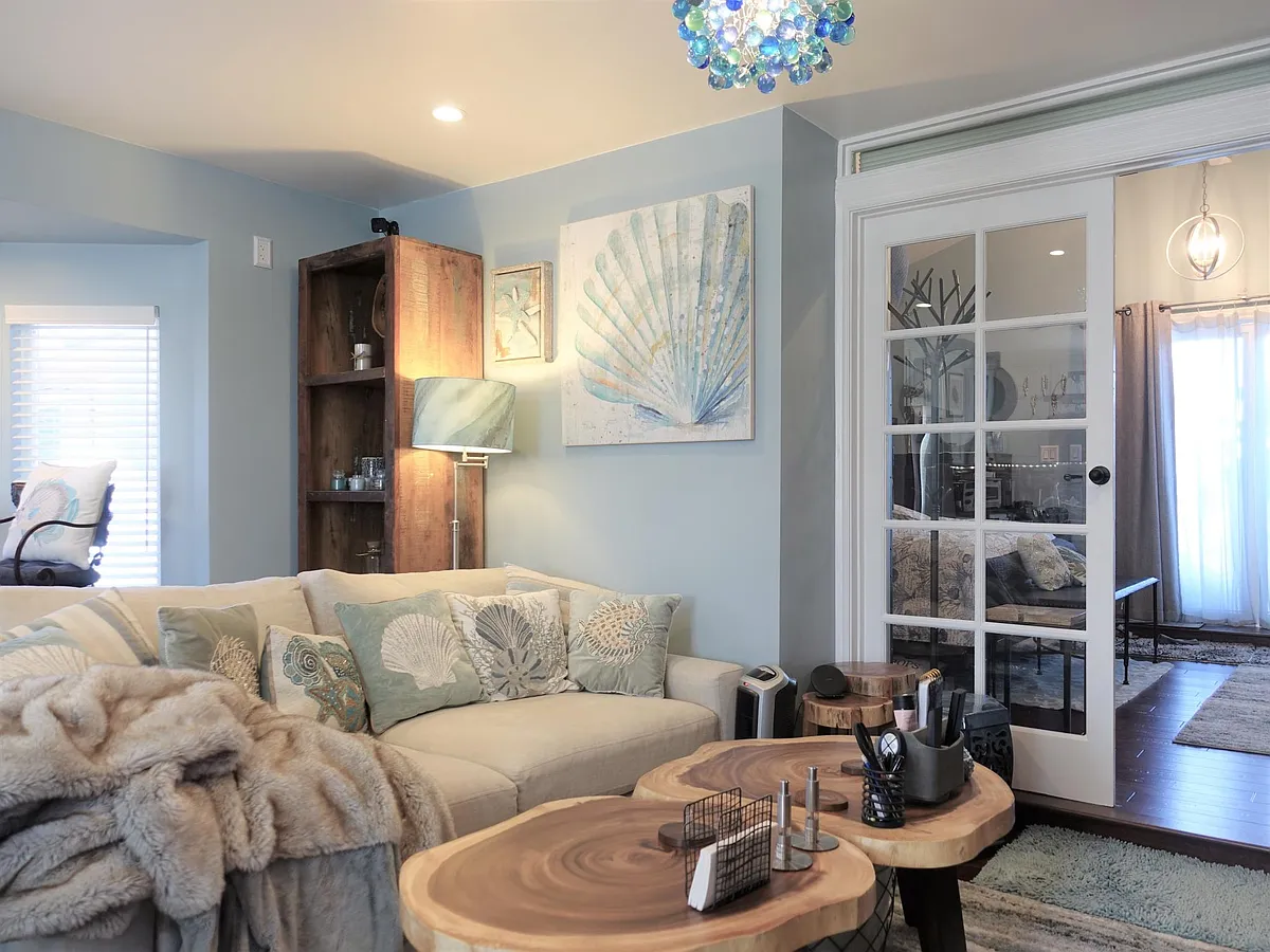 Living room with an oversized sofa. - 831 Gladiola Dr #2