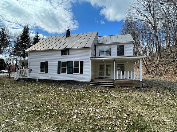 East side of home with covered porch.