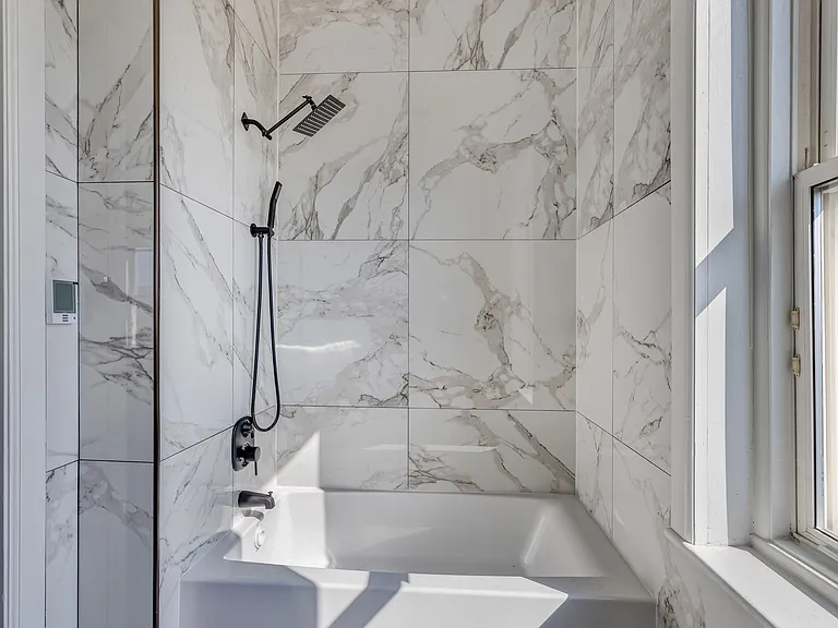 Floor to ceiling bathroom tile.