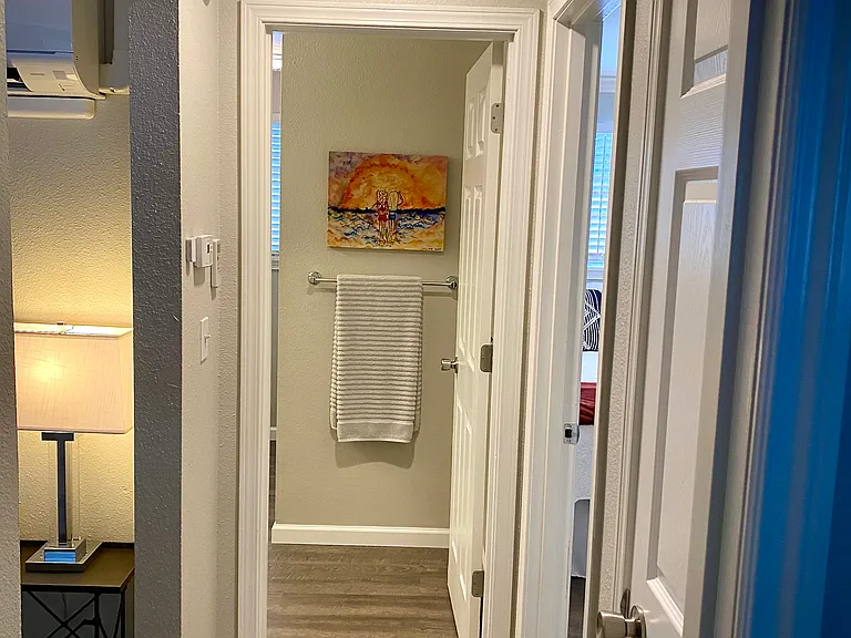 Hallway to bathroom and door to linen closet