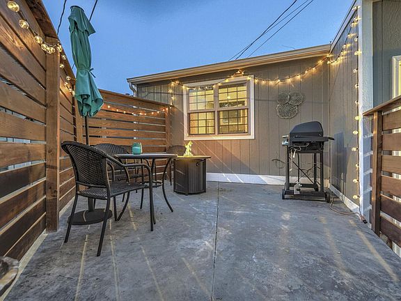 Cute front yard with a fire pit, grill, table and chairs!