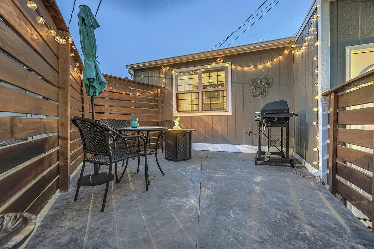 Cute front yard with a fire pit, grill, table and chairs! - S Tejon St