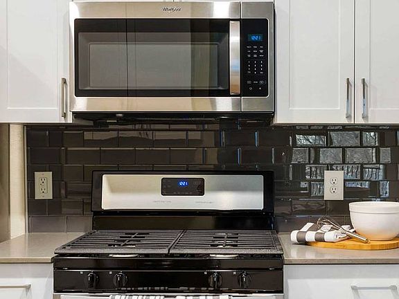 Finish Package II kitchen with stainless steel appliances and tile backsplash