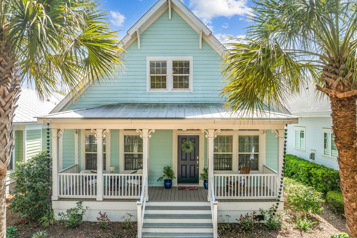 A welcoming Amelia Park classic, framed by palms and a wide front porch made for slowing down.