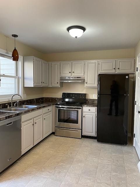 Kitchen includes stove, refrigerator, dishwasher.