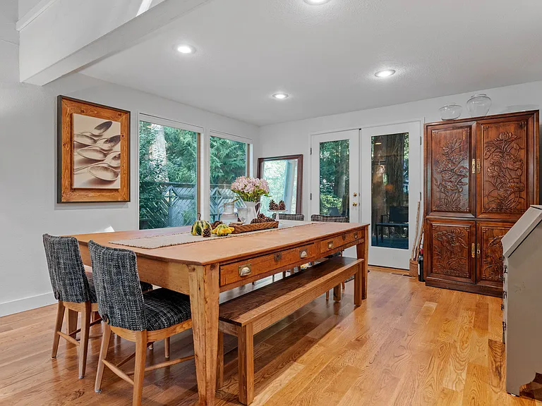 View of dining table, armoire and french door to back deck