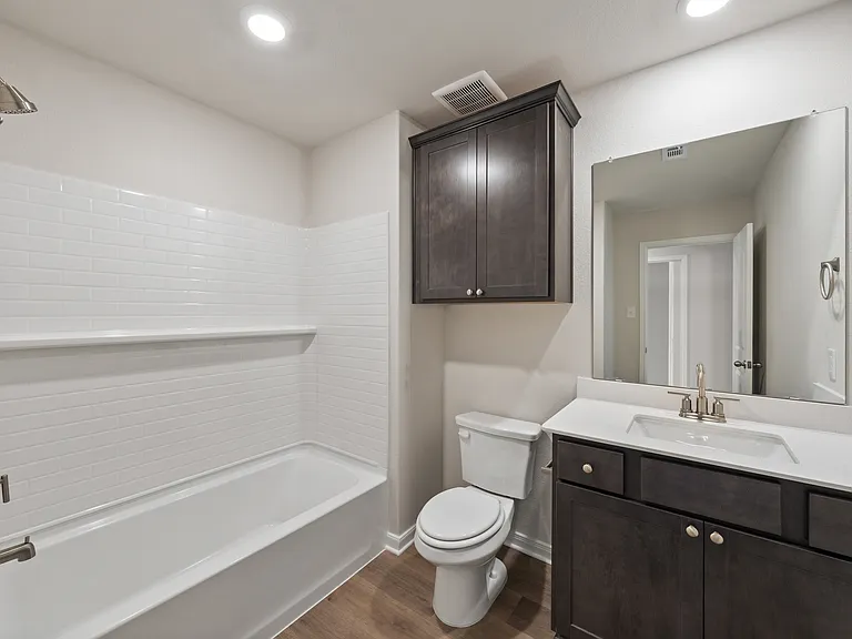 The secondary bathroom has a great vanity and shower-tub combo.