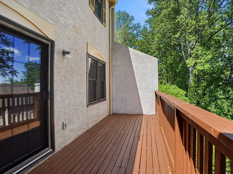 Serene balcony with lush green views.