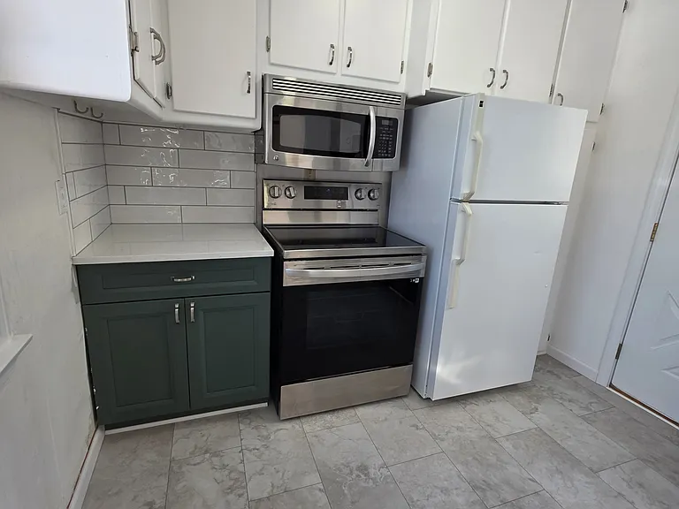 Stainless steel electric glass top range and oven.