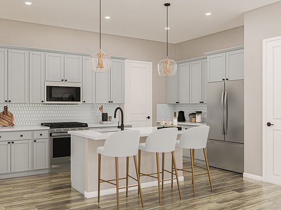 Example of Kitchen with White Quartz Countertops, Warm Grey Cabinetry and Laminate Wood Flooring