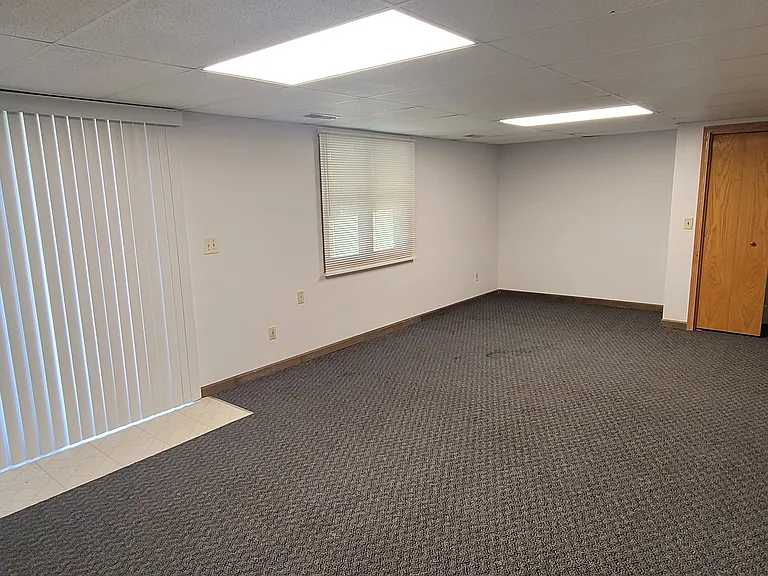 View of the third bedroom from the corner showing exit to the patio and the closet.