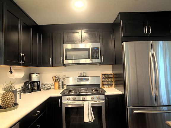 Fully stocked kitchen with premium appliances and LED smart lighting.