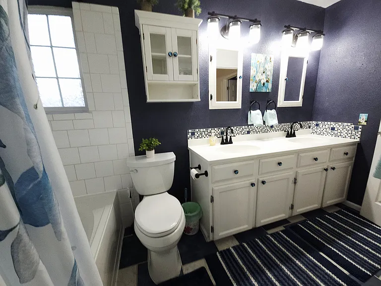 Main bathroom with full shower and tub. On upper level