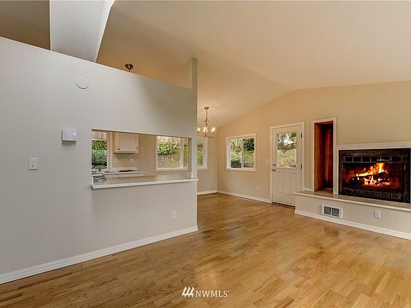 Open concept living with cozy wood-burning fireplace.