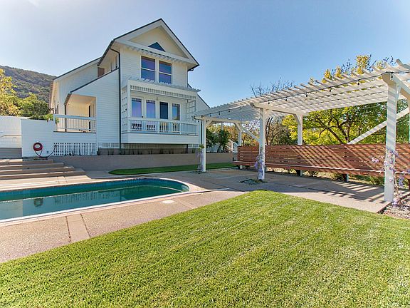 Backyard Pool, trellised patio and lawn.
