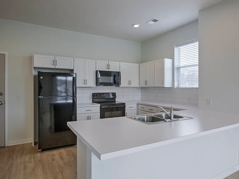 Full-sized refridgerator in a kitchen at The Rise.
