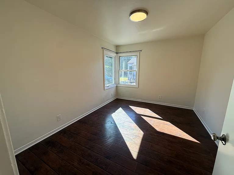 Bedroom #1 with multiple corner windows and spacious double door closet.