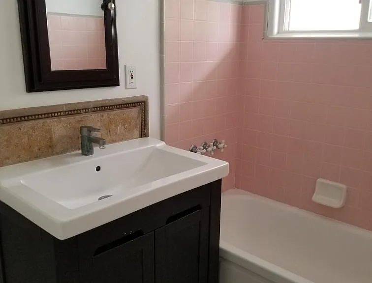 Second bathroom. Vintage period correct 1957 pink & gray tile in shower tub.