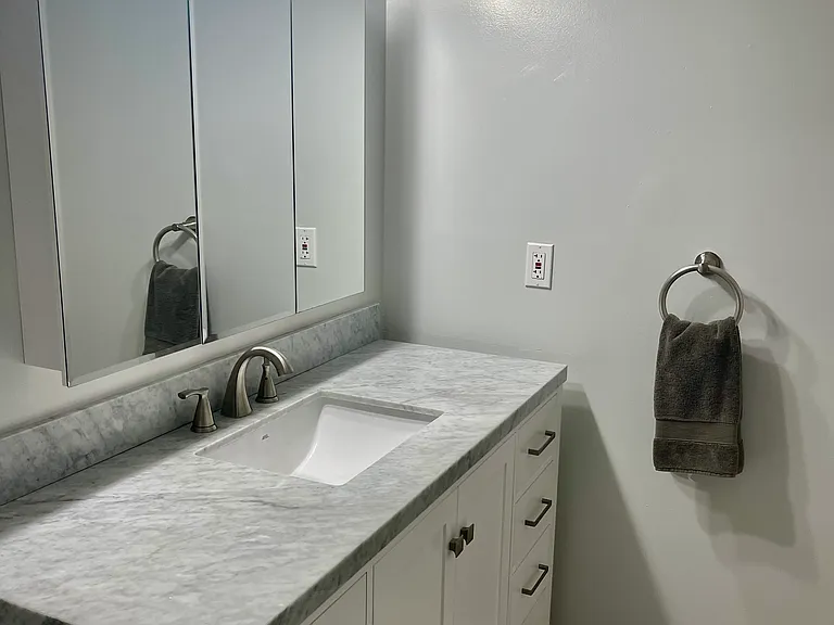Updated Bath features Mirrored Medicine Cabinet & Modern Vanity with Marble Countertop