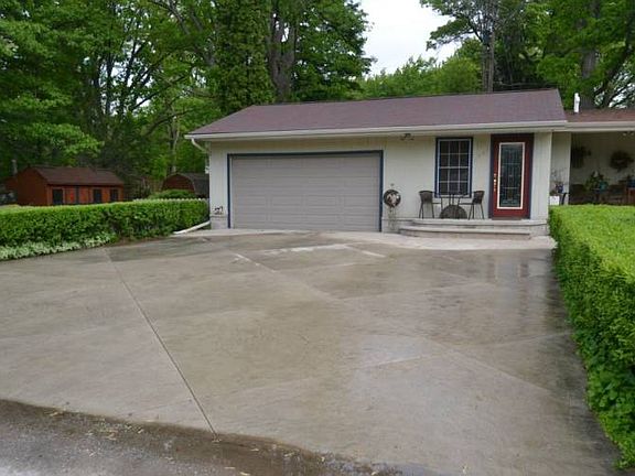 The driveway is done in a unique design and is extra wide for additional parking.  It brings you right up to the Two car garage and access to the fenced in backyard.