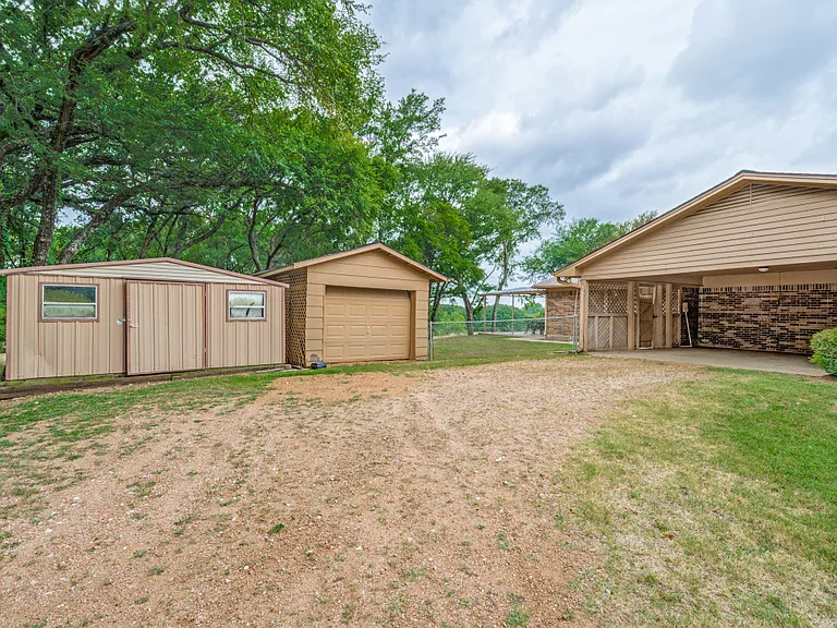Covered car port and 2 extra garages for storage