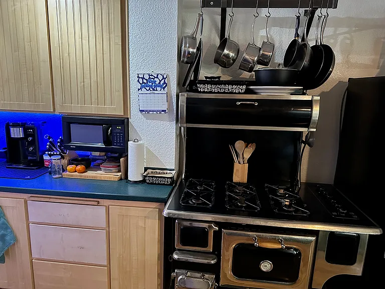 Modern stove with 6 gas burners and electrical oven in the old woodstove style.