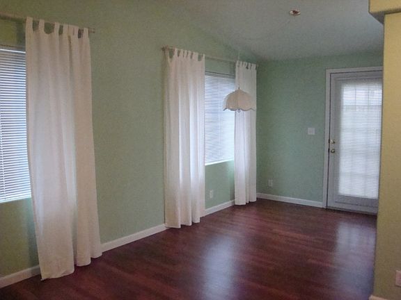 Dining room with door that leads to back covered deck.