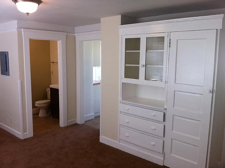 Living room built-in with small closet, bath, doorway to kitchen