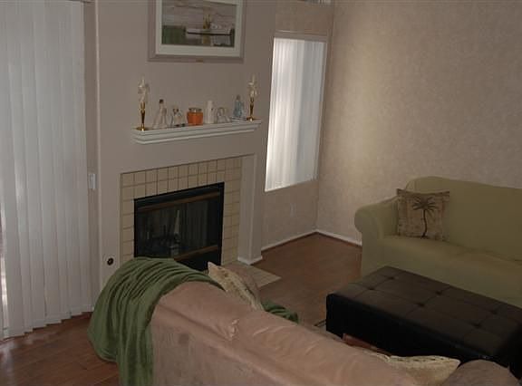 Living Room w/fireplace and large windows, vaulted ceiling