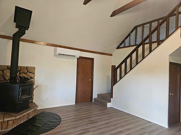 Livingroom with wood stove, and minisplit heating/cooling unit