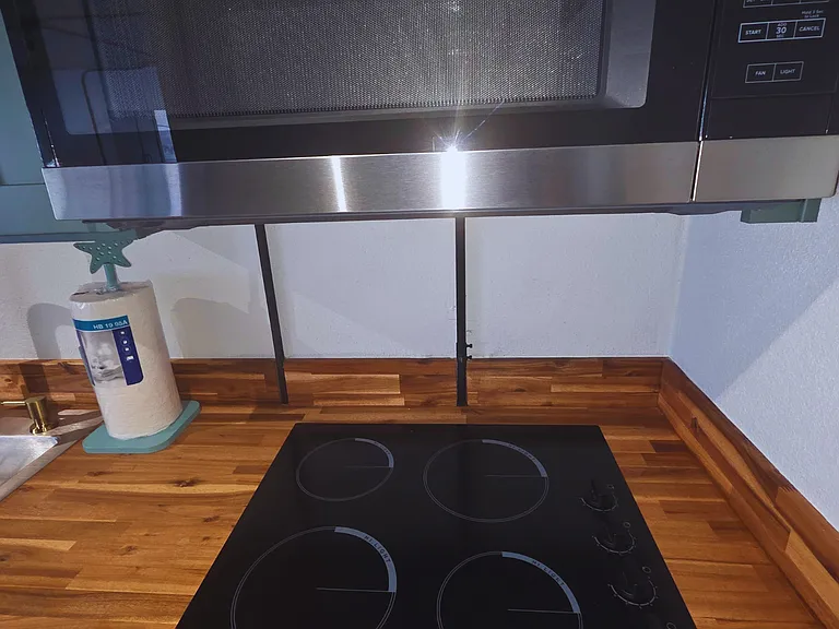 Contemporary kitchen featuring glass cooktop & microwave essentials