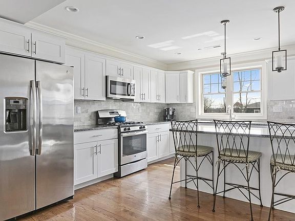 Open Kitchen to dining and living area. Granite Counters, Marble Backsplash, with stainless appliances