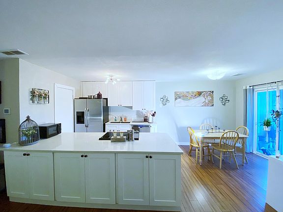 updated kitchen and entry to laundry room. entrance to one of the two balconies by dining room area