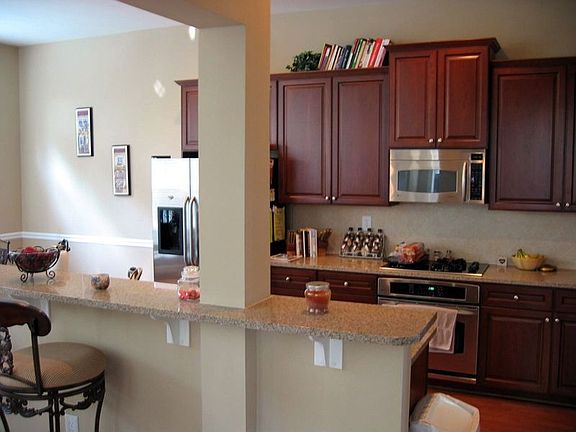 Kitchen has all the upgrades, stainless appliances, cherry cabinets, granite counters!
