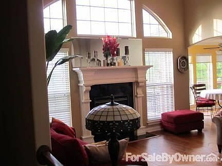 Family Room : Custom made mantel with black granite hearth, with arched windows,