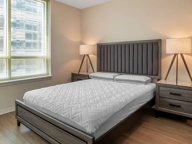 Furnished+ apartment homes feature queen bed with mattress, two pillows, dresser, nightstands, lamp, and mirror. (Representative Image exact items and style of furnishings may vary)