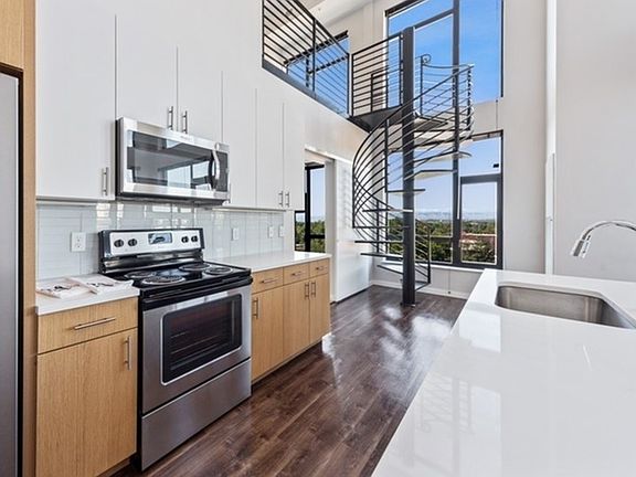 2 Bedroom w/ Loft with two-tone walnut cabinetry and pearl countertops.