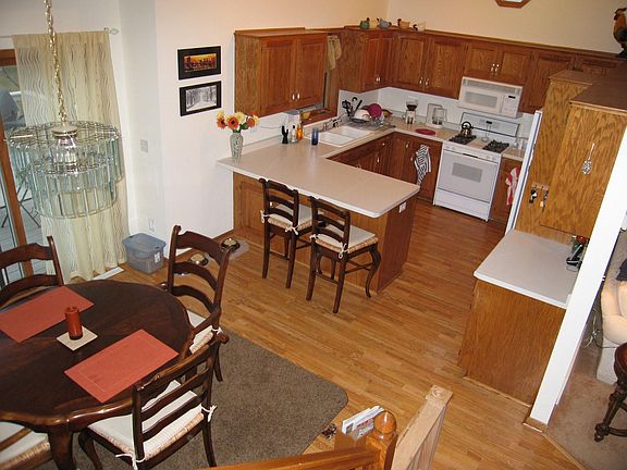 Large kitchen and informal dining with laminate floor and walkout to deck