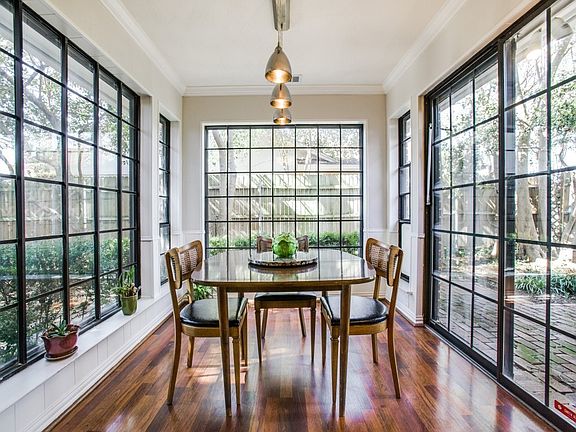 Atrium breakfast room looks into an English Garden bird sanctuary makes morning meals a fantasy come to life.