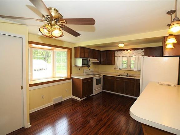 Plenty of Wood Cabinets in Massive 21x13 Eat-in Kitchen w/ Beautiful Bay Window, Newer Flooring (2 yrs), Newer Counter Tops & Br