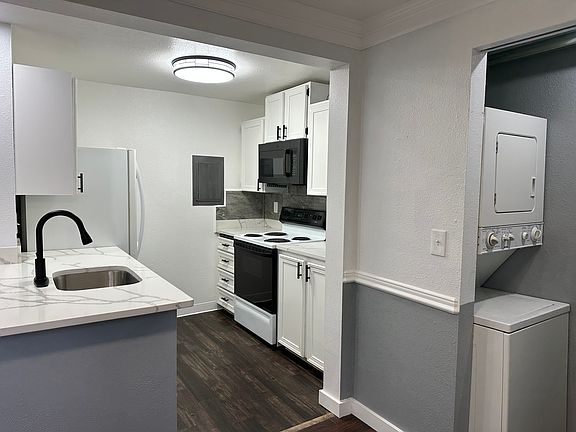 Open kitchen - easy for entertaining + conveniently located laundry space!