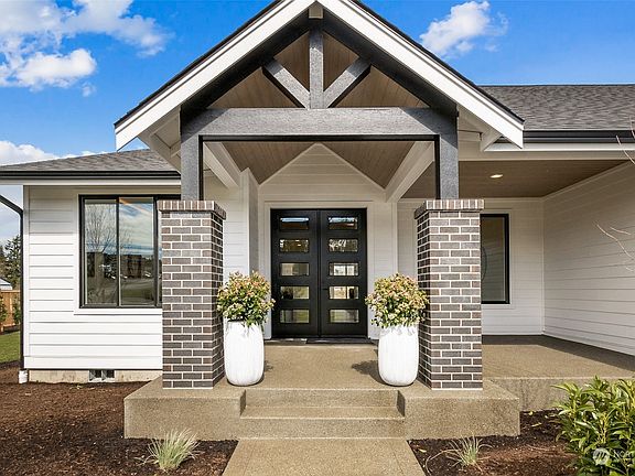 The covered front porch not only provides shelter for arriving guest or deliveries, it also includes additional space for gathering.>