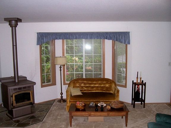The pellet stove and bay window in the living room make for a warm cozy setting in the cooler weather.