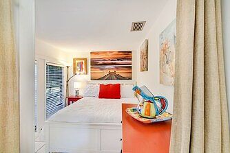 Front entrance bedroom with a double bed, overlooking the front entrance private garden.