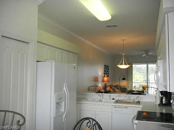 Kitchen area has table for 4 plus a bar on living room side