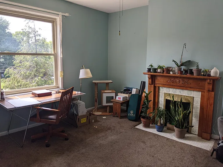 Bedroom #3 on second floor with decorative fireplace and mantle. Currently being used as an office.