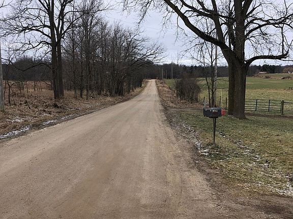 Front road view west, quiet country setting