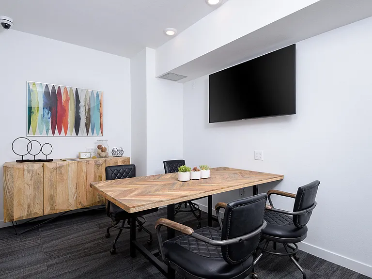 Collaborative workspace with conference table and television
