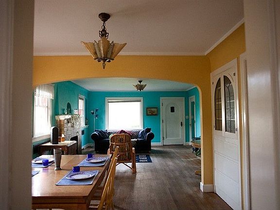 Period style chandelier in generous dining room. Pretty built-in cabinet with leaded glass doors. Wood floors and generous baseboards in living and dining.